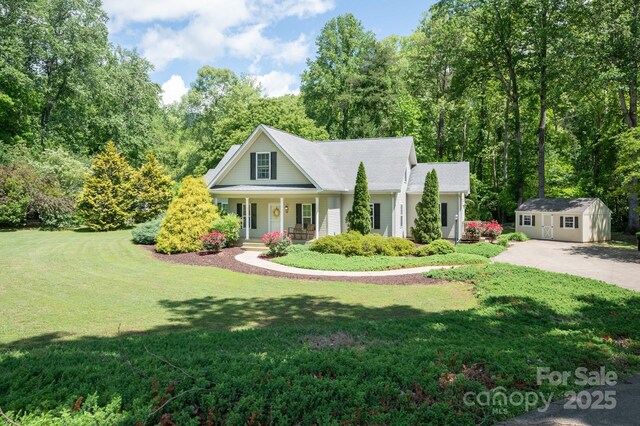 19 Lynnbrook Way, Columbus, NC 28722 - view of front of house with a porch, a shed, an outdoor structure, and a front lawn