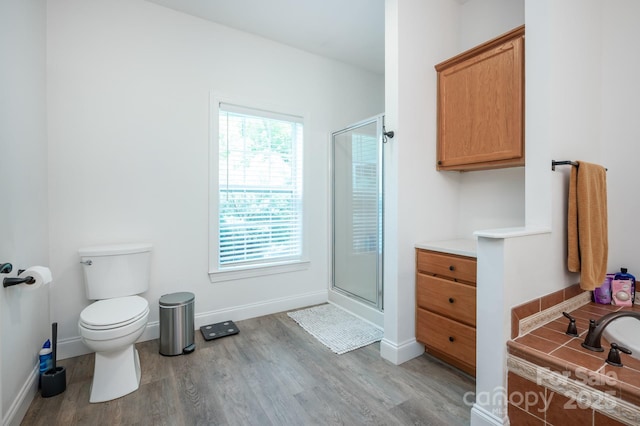 19 Lynnbrook Way, Columbus, NC 28722 - bathroom with wood finished floors, a shower stall, toilet, and baseboards