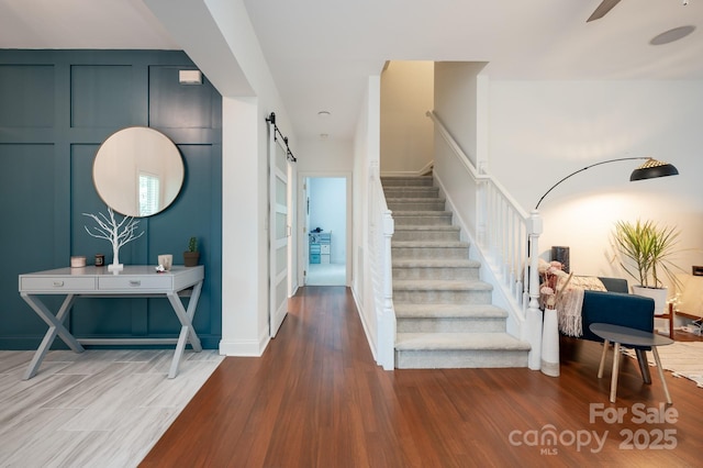19 Lynnbrook Way, Columbus, NC 28722 - staircase with a barn door, wood finished floors, and a ceiling fan