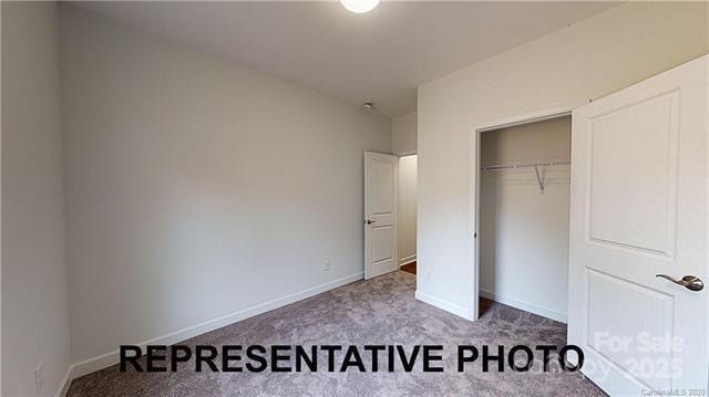 unfurnished bedroom featuring carpet, a closet, and baseboards