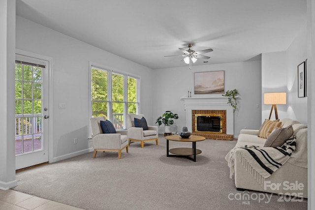 15831 Breton Brook St, Huntersville, NC 28078 - carpeted living room featuring a fireplace, a ceiling fan, baseboards, and tile patterned floors