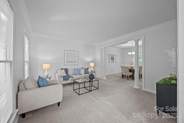 15831 Breton Brook St, Huntersville, NC 28078 - carpeted living room featuring crown molding, a chandelier, and decorative columns