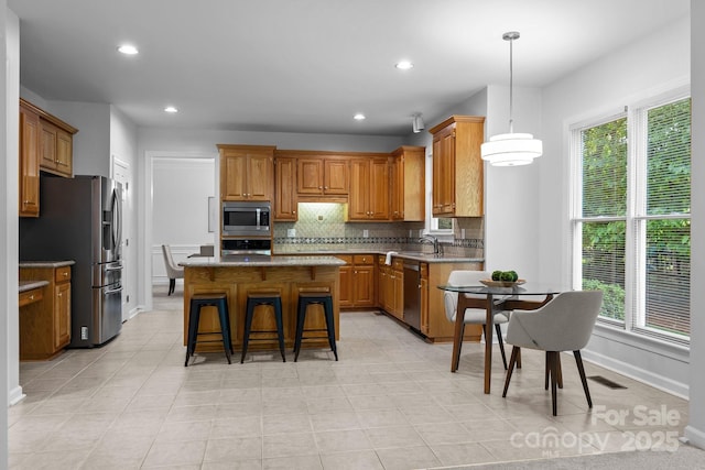 15831 Breton Brook St, Huntersville, NC 28078 - kitchen featuring stainless steel appliances, backsplash, a center island, healthy amount of natural light, and recessed lighting