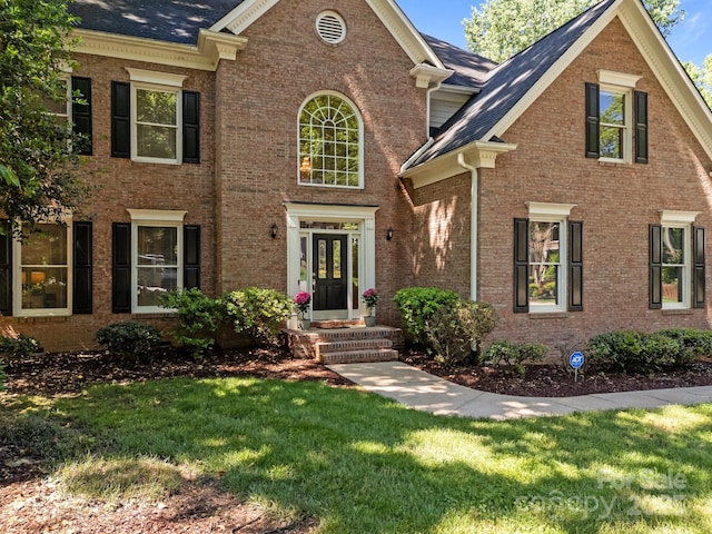 15831 Breton Brook St, Huntersville, NC 28078 - colonial-style house featuring brick siding, a front yard, and roof with shingles