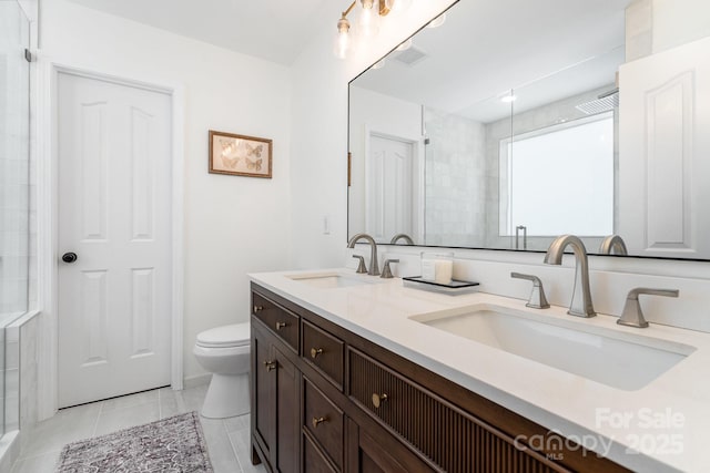 full bath with toilet, a shower, double vanity, and tile patterned floors