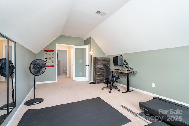 workout room with carpet floors, vaulted ceiling, and baseboards