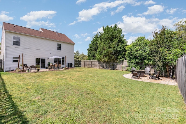 view of yard with an outdoor fire pit, a patio area, and central AC unit
