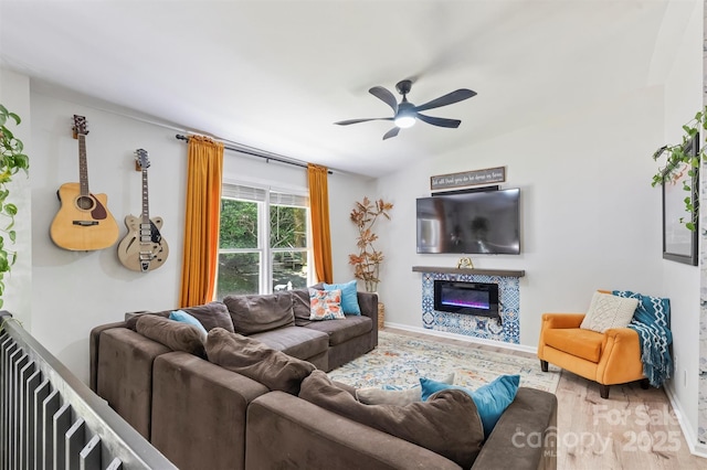27037 Tidal Way, Tega Cay, SC 29708 - living area with wood finished floors, ceiling fan, a glass covered fireplace, and vaulted ceiling
