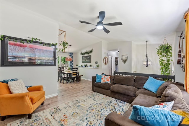 27037 Tidal Way, Tega Cay, SC 29708 - living area featuring ceiling fan, wood finished floors, lofted ceiling, baseboards, and a chandelier