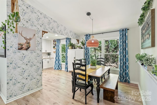 27037 Tidal Way, Tega Cay, SC 29708 - dining space featuring light wood-style flooring, baseboards, wallpapered walls, and vaulted ceiling