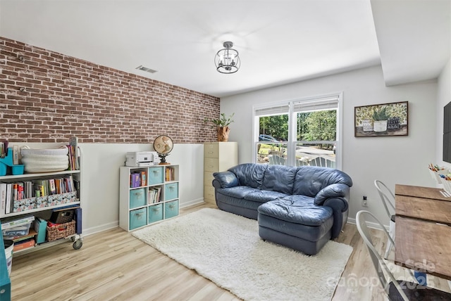 27037 Tidal Way, Tega Cay, SC 29708 - living room with brick wall, wood finished floors, and baseboards
