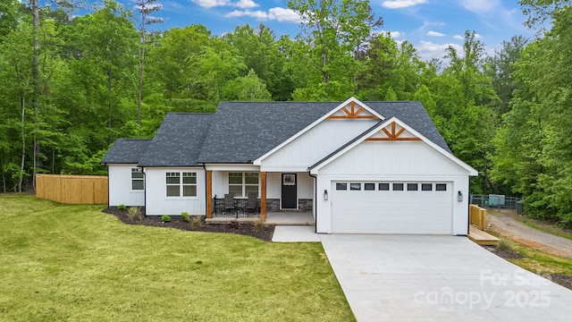 view of front of property featuring a porch, a garage, a shingled roof, concrete driveway, and board and batten siding