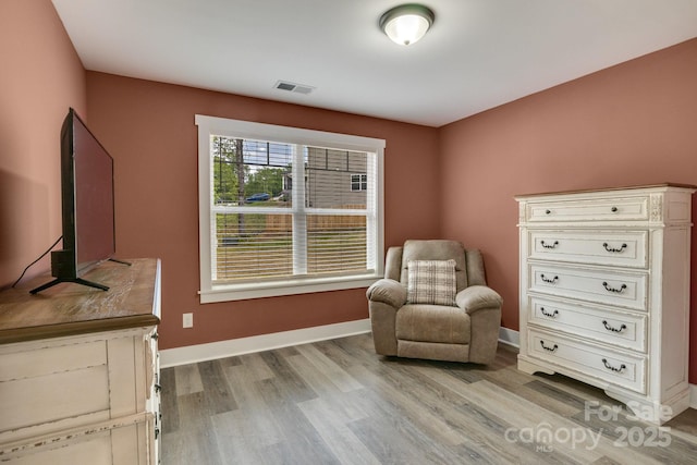 sitting room featuring light wood finished floors and baseboards
