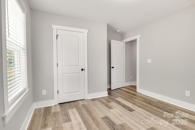 1222 Summerhill St SW, Lenoir, NC 28645 - unfurnished bedroom with light wood-type flooring and baseboards