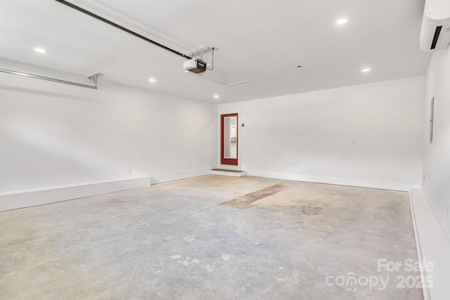1222 Summerhill St SW, Lenoir, NC 28645 - garage featuring an AC wall unit, a garage door opener, and recessed lighting