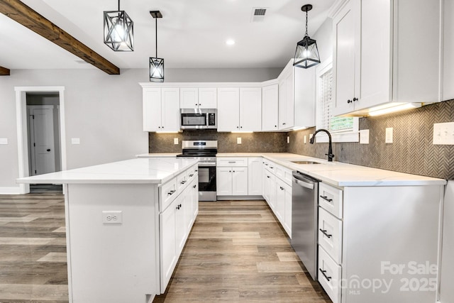 1222 Summerhill St SW, Lenoir, NC 28645 - kitchen featuring stainless steel appliances, a center island, light wood-type flooring, decorative backsplash, and recessed lighting