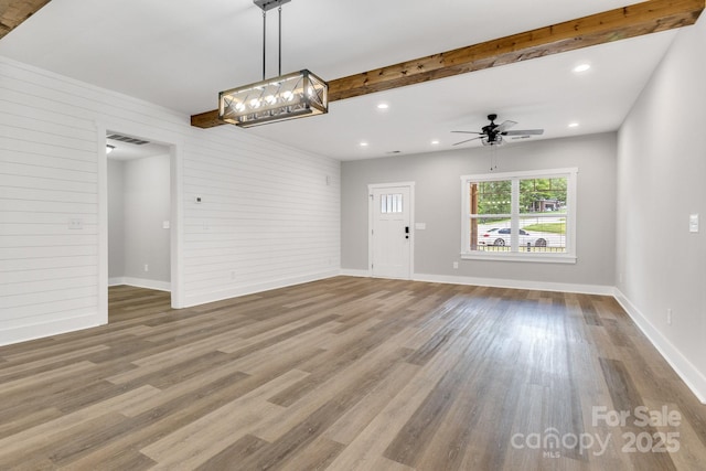 1222 Summerhill St SW, Lenoir, NC 28645 - unfurnished living room featuring wood finished floors, beam ceiling, ceiling fan, and recessed lighting