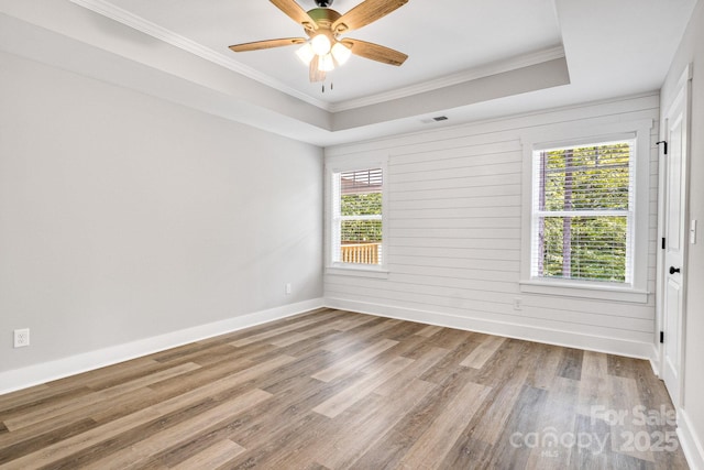 1222 Summerhill St SW, Lenoir, NC 28645 - unfurnished room featuring wood finished floors, ornamental molding, ceiling fan, and a raised ceiling