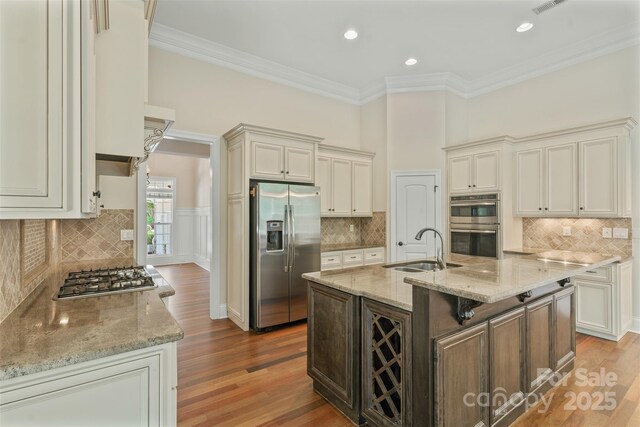 104 Whiterock Dr, Mount Holly, NC 28120 - kitchen featuring appliances with stainless steel finishes, a sink, backsplash, ornamental molding, and light stone countertops