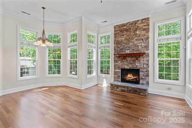 104 Whiterock Dr, Mount Holly, NC 28120 - unfurnished living room with baseboards, wood finished floors, a fireplace, a chandelier, and crown molding