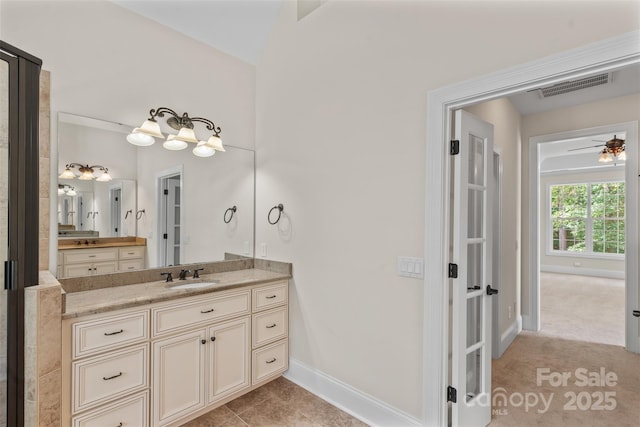 104 Whiterock Dr, Mount Holly, NC 28120 - bathroom with vanity, baseboards, and vaulted ceiling