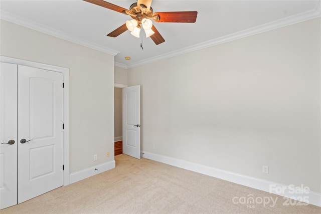 104 Whiterock Dr, Mount Holly, NC 28120 - unfurnished bedroom with light colored carpet, crown molding, baseboards, ceiling fan, and a closet