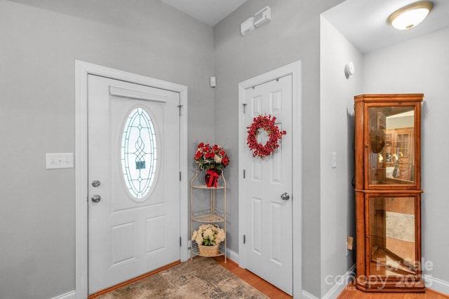 entrance foyer with light wood-style floors and baseboards