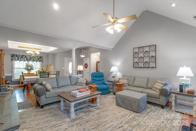 living room featuring wood finished floors, a ceiling fan, a chandelier, recessed lighting, and baseboards