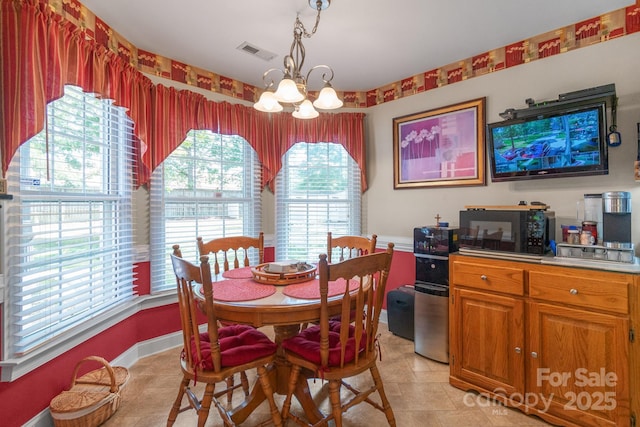 dining space featuring a chandelier and light tile patterned floors