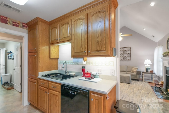 kitchen with dishwasher, a sink, light countertops, vaulted ceiling, and decorative backsplash