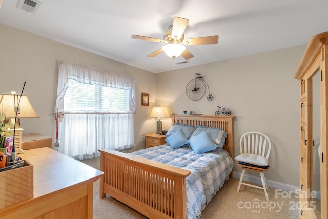 bedroom with light colored carpet, baseboards, and a ceiling fan