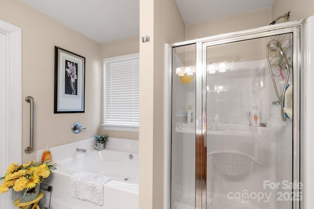 bathroom featuring a stall shower and a garden tub