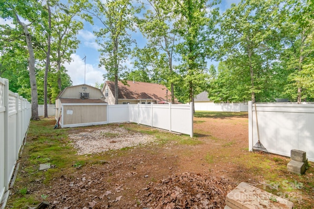 fenced backyard featuring a storage shed and an outdoor structure