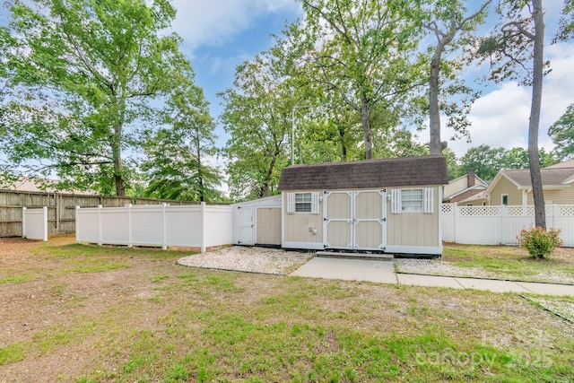 view of yard featuring a storage unit and an outbuilding