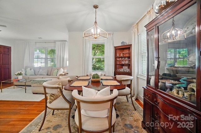 4647 General Pershing Dr, Charlotte, NC 28209 - living area featuring a chandelier and wood finished floors