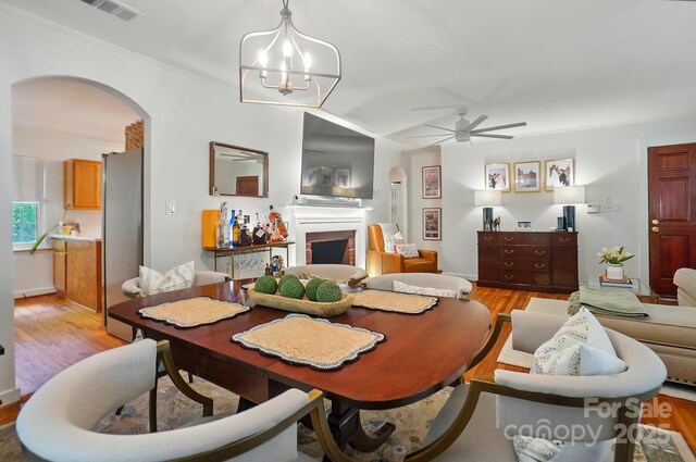 4647 General Pershing Dr, Charlotte, NC 28209 - dining room featuring arched walkways, light wood finished floors, and ceiling fan