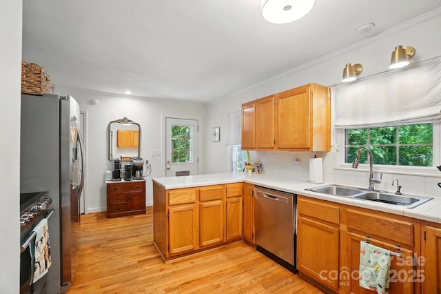 4647 General Pershing Dr, Charlotte, NC 28209 - kitchen with appliances with stainless steel finishes, a sink, light wood-style floors, a peninsula, and healthy amount of natural light