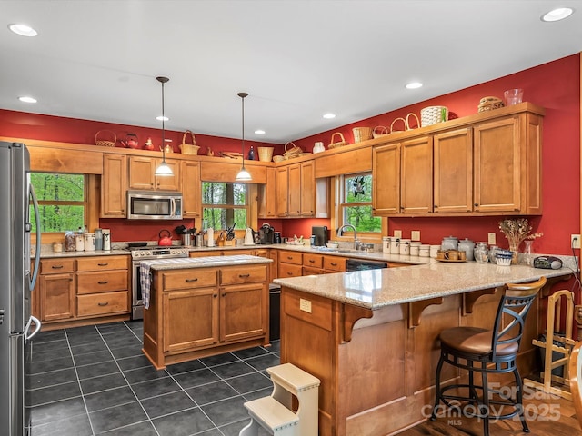 917 Otter Mountain Rd, Topton, NC 28781 - kitchen featuring stainless steel appliances, a sink, a peninsula, light stone countertops, and dark tile patterned flooring