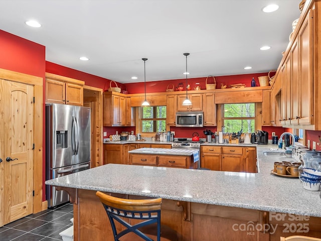 917 Otter Mountain Rd, Topton, NC 28781 - kitchen with appliances with stainless steel finishes, a sink, a peninsula, dark tile patterned flooring, and light stone countertops