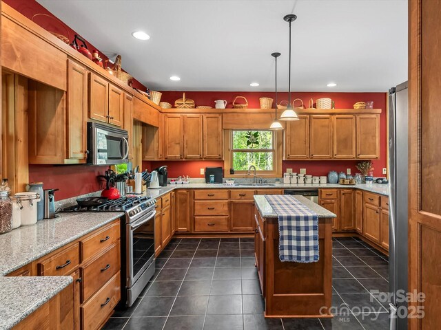 917 Otter Mountain Rd, Topton, NC 28781 - kitchen with appliances with stainless steel finishes, brown cabinetry, a sink, dark tile patterned flooring, and recessed lighting