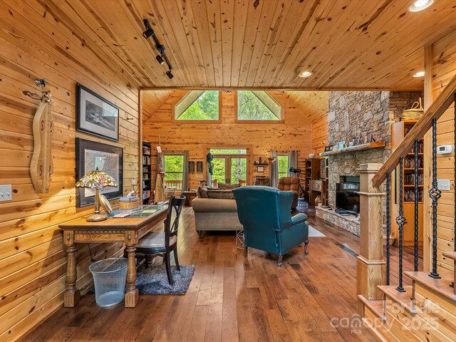 917 Otter Mountain Rd, Topton, NC 28781 - living area with wooden ceiling, hardwood / wood-style flooring, a stone fireplace, wood walls, and stairway
