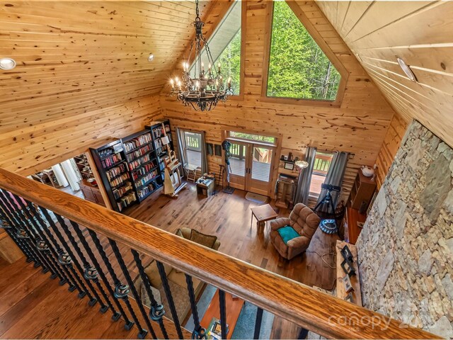 917 Otter Mountain Rd, Topton, NC 28781 - stairway featuring hardwood / wood-style floors, wood walls, a chandelier, french doors, and high vaulted ceiling
