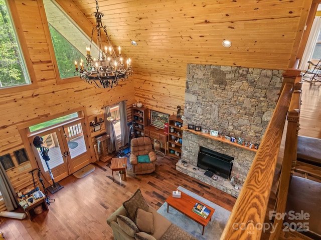 917 Otter Mountain Rd, Topton, NC 28781 - living area featuring wood-type flooring, a chandelier, wood walls, and a fireplace