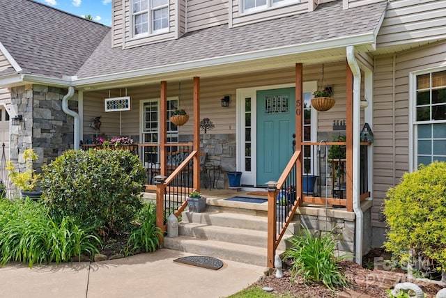 50 Pinerose Dr, Weaverville, NC 28787 - property entrance with a shingled roof, stone siding, and a porch