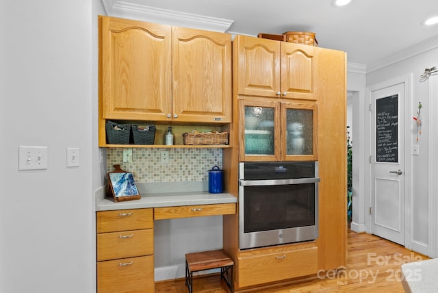 50 Pinerose Dr, Weaverville, NC 28787 - kitchen featuring oven, decorative backsplash, crown molding, light wood-style floors, and light countertops