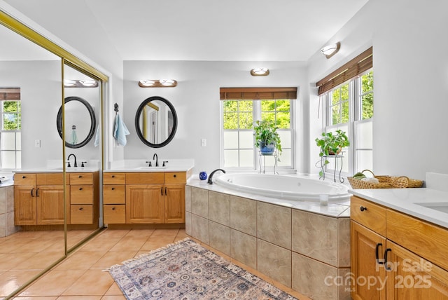 50 Pinerose Dr, Weaverville, NC 28787 - bathroom with healthy amount of natural light, tile patterned floors, a bath, and two vanities
