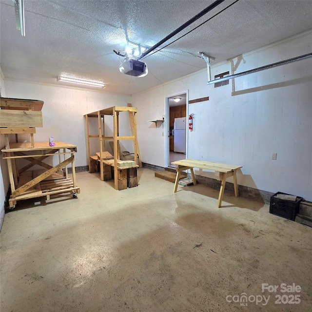 6573 Weldon Cir NW Unit 22, Concord, NC 28027 - garage with freestanding refrigerator, a garage door opener, and a workshop area
