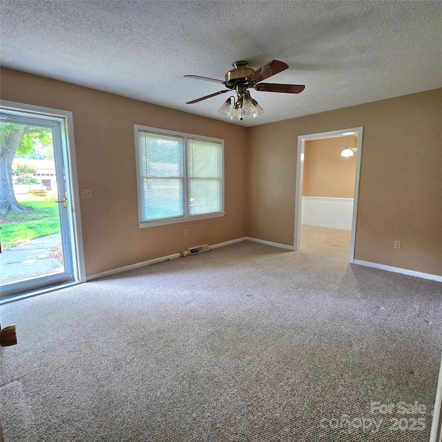 6573 Weldon Cir NW Unit 22, Concord, NC 28027 - unfurnished room with carpet floors, plenty of natural light, a ceiling fan, and a textured ceiling