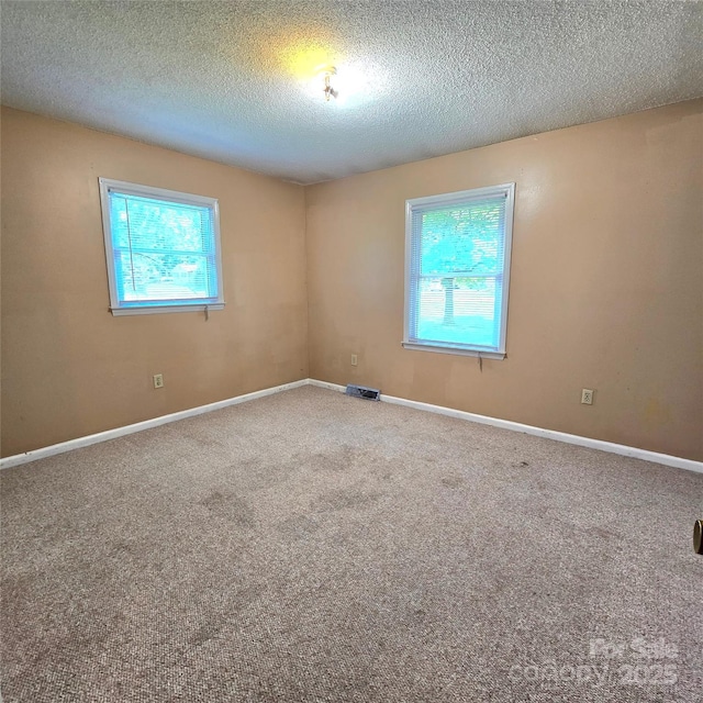 6573 Weldon Cir NW Unit 22, Concord, NC 28027 - carpeted empty room with healthy amount of natural light, a textured ceiling, and baseboards