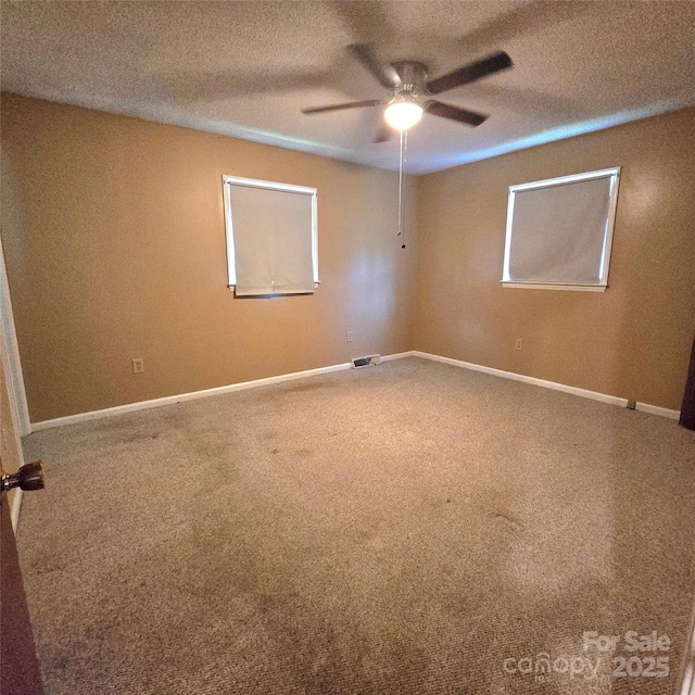 6573 Weldon Cir NW Unit 22, Concord, NC 28027 - empty room with a ceiling fan, a textured ceiling, carpet flooring, and baseboards
